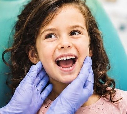 A smiling child at the dentist's chair